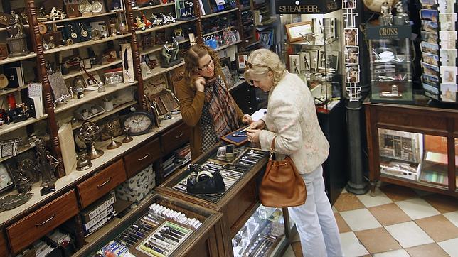 Una clienta acude a la Papelería Ferrer en la calle Sierpes