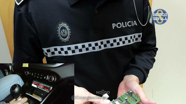 Un agente enseña la placa del taxímetros